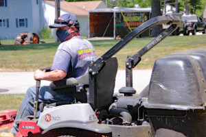 Groundhlg Landscaping employee on riding lawnmower