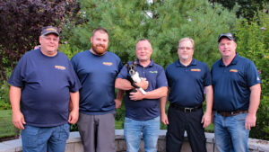Groundhog Landscaping team members posing together outdoors, showcasing teamwork and commitment to landscaping services.
