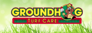 Groundhog Turf Care logo featuring a cartoon groundhog holding a shovel, set against a grassy background, representing Groundhog Landscaping's focus on landscaping and irrigation services.
