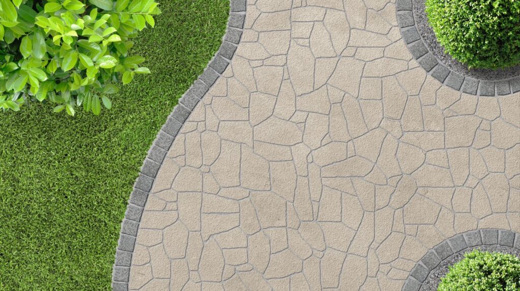 Hardscape design featuring a textured stone patio bordered by circular stone planters and lush greenery, illustrating the foundational elements of outdoor spaces in landscape planning.
