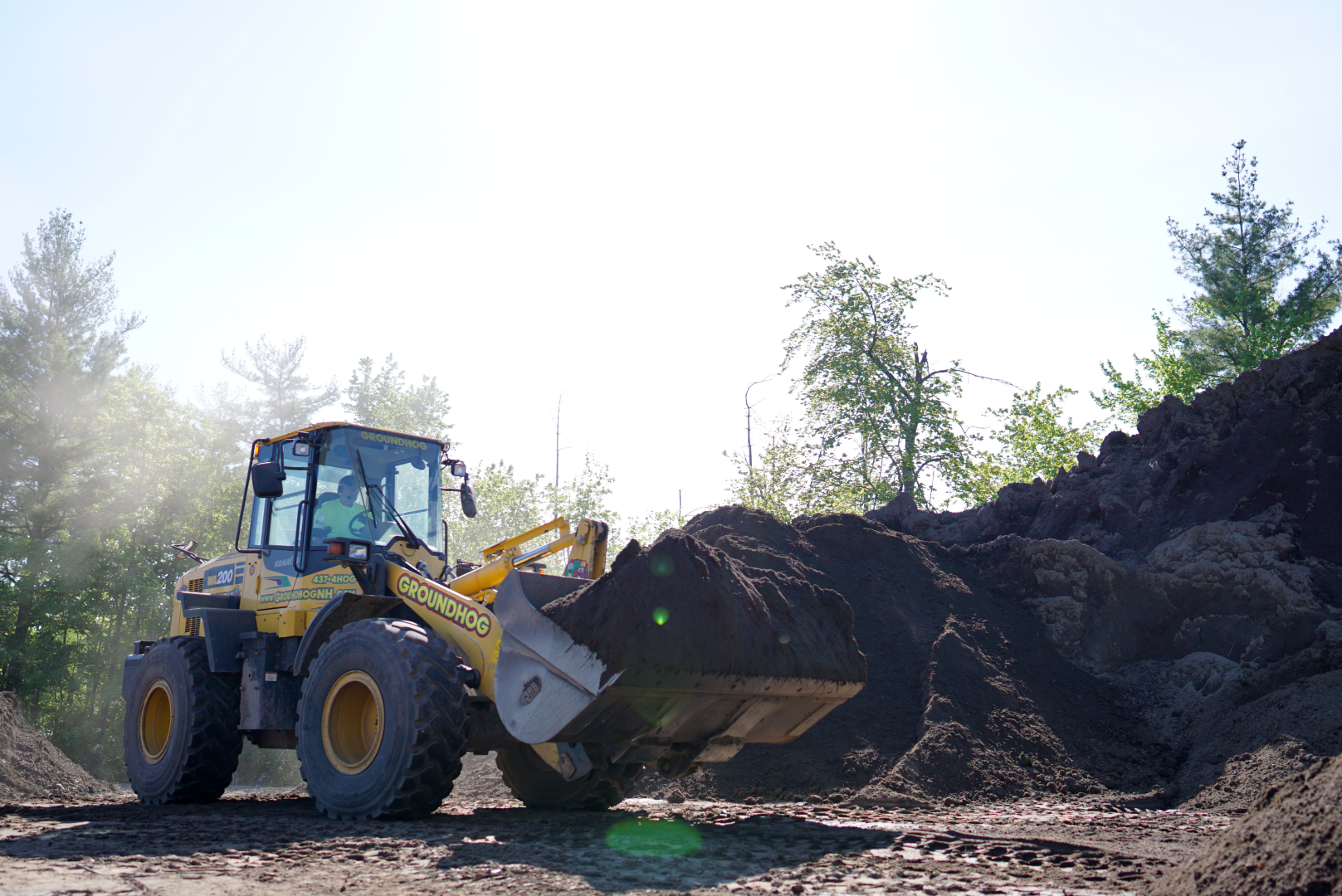 loader bucket full of bulk compost