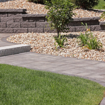 Paver patio and walkway hardscape design by Groundhog Landscaping in Derry, NH.