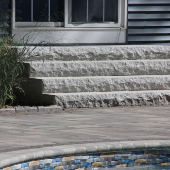 Granite steps and patio hardscaping design by Groundhog Landscaping in Derry, NH.