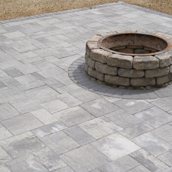 Paver patio and fire pit design by Groundhog Landscaping in Derry, NH.