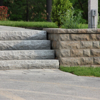 Granite steps and retaining wall hardscape design by Groundhog Landscaping in Derry, NH.